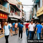 Home 21 마카오 최신 사건 사고 - A bustling street scene in Macau during a busy tourist season, showing diverse groups of people navi...